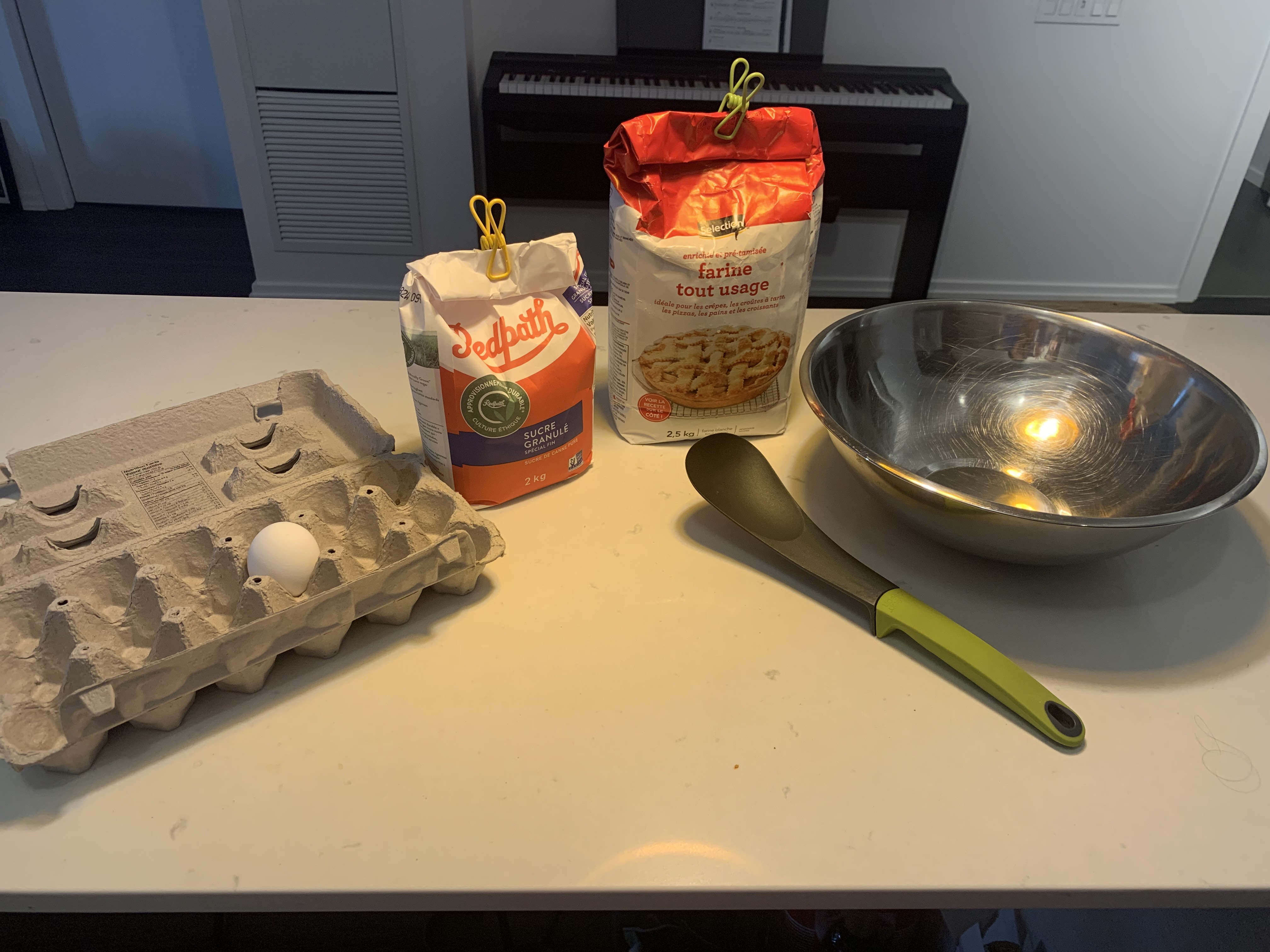 Robot: I am a robot operating in a kitchen. Given <b>img</b>, When a human asks me to do a task, I will respond with the sequence of actions I would do to accomplish the task with only the items I see.  Human: Use all of the ingredients you see to make a cake batter. [sep]1. crack egg. 2. put egg in bowl. 3. put flour in bowl. 4. put sugar in bowl. 5. mix. 6. put in pan. 7. bake. 8. eat. 9. clean up.