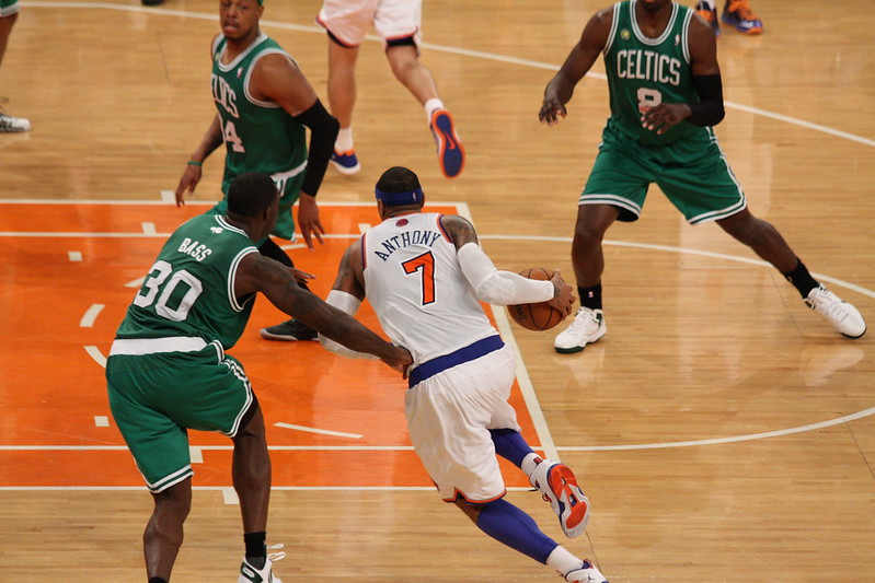 Given <b>img</b>. Q: Who are the two teams playing in this photo, and which was the last to win a championship, and which year did they win, and who was their star player that year? A: Let's think step by step. [sep]  1. team in white is new york knick. 2. team in green is boston celtic. 3. last to win championship was boston celtic. 4. year was 2008. 5. star player was paul pierce. 6. i am not sure if this is correct. i am not basketball fan. i just google it. 